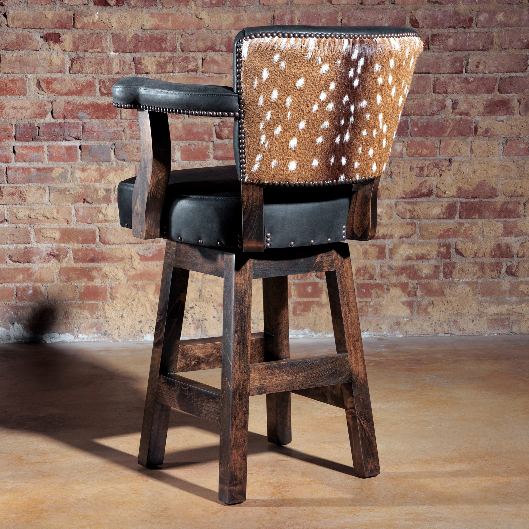 Rear view of luxury bar stool showing axis hide backrest with nailhead trim.