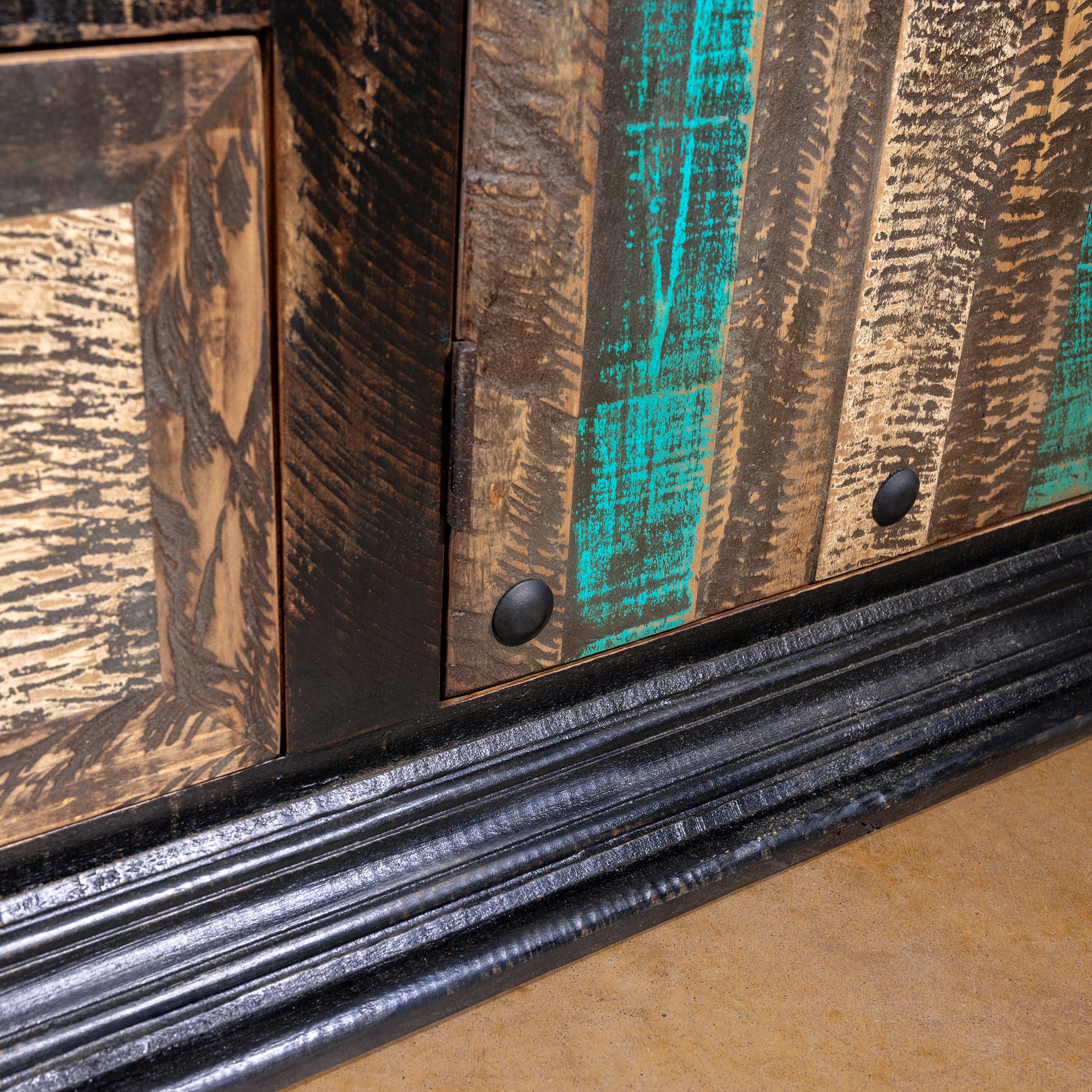 Base detail of High Desert Hacienda Buffet showing layered texture and iron studs