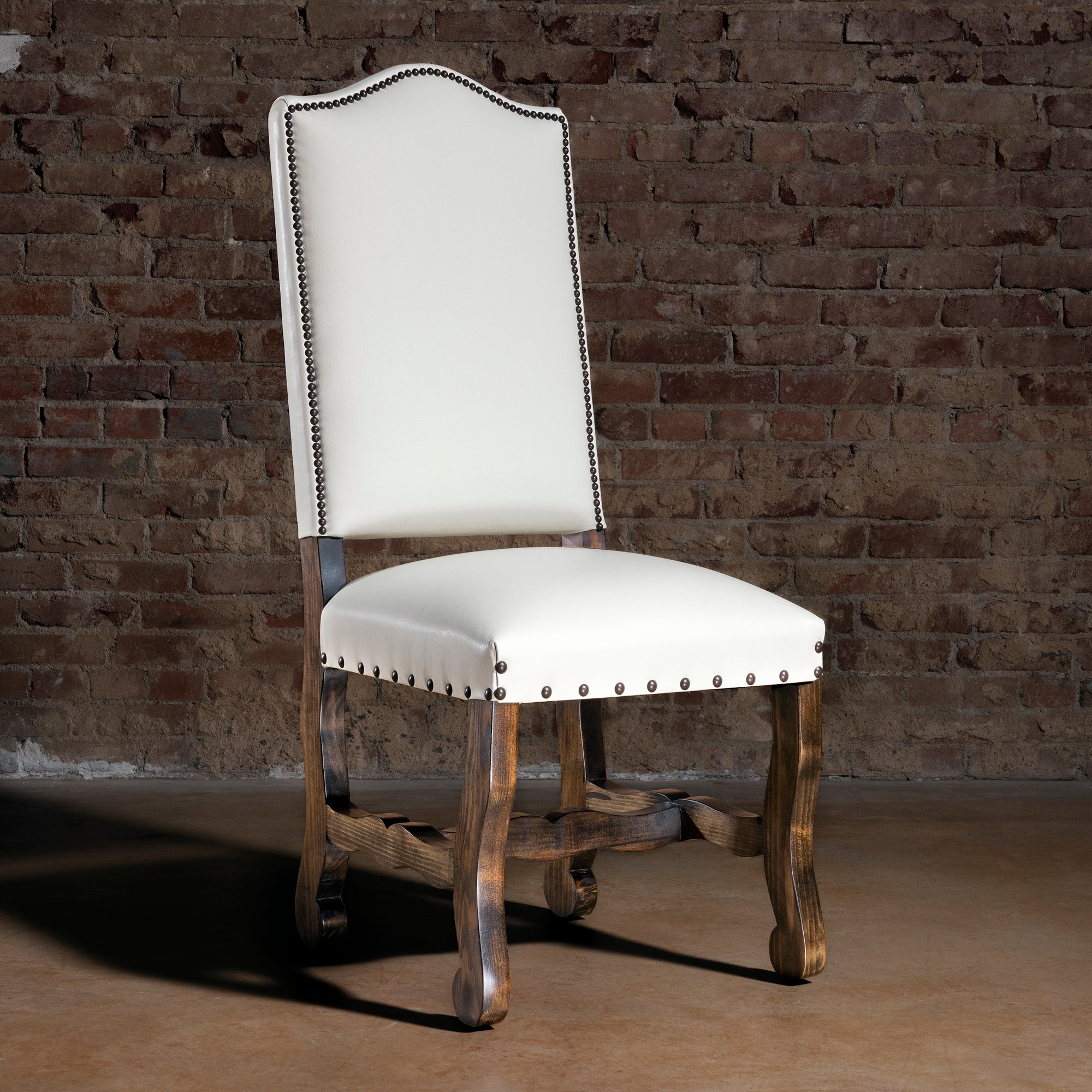 High Plains Ivory Western leather dining chair in rustic brick loft setting