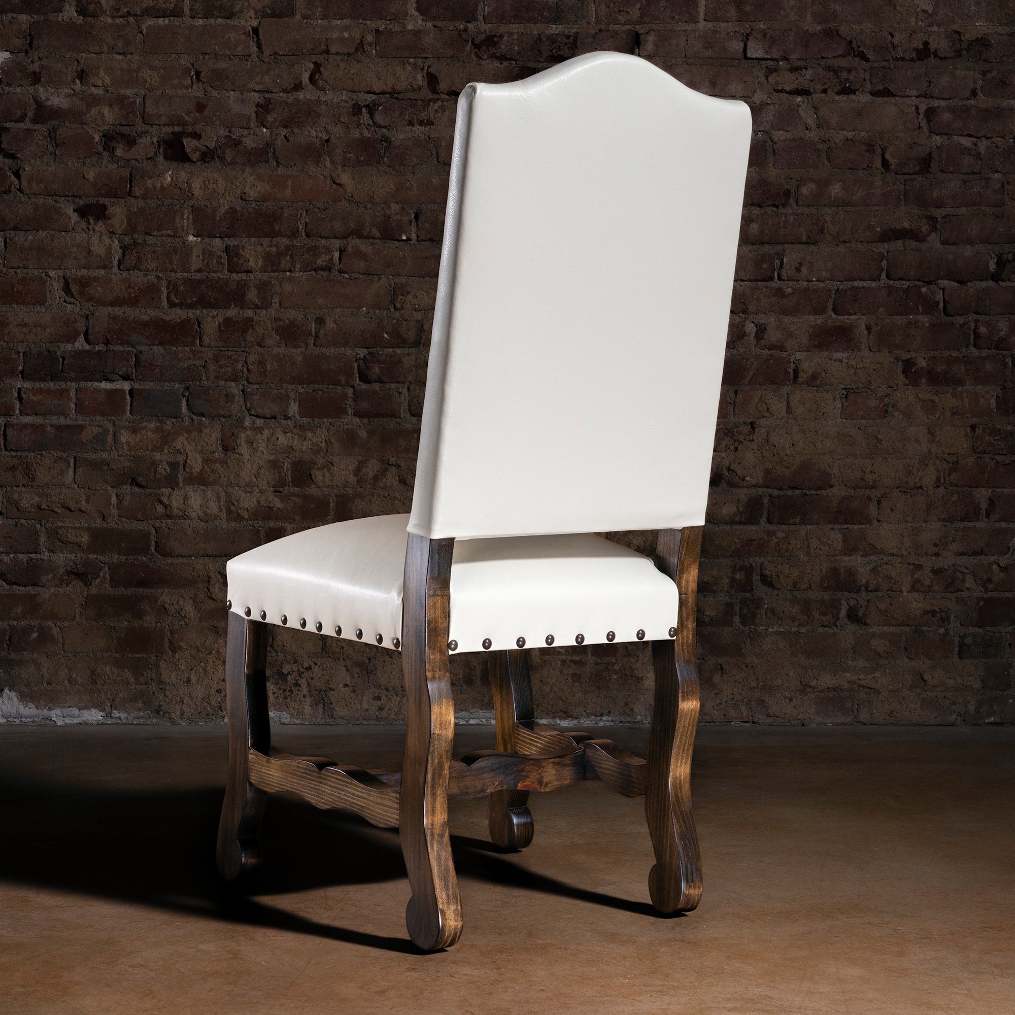 Back view of High Plains Ivory white leather Western dining chair with carved wood legs