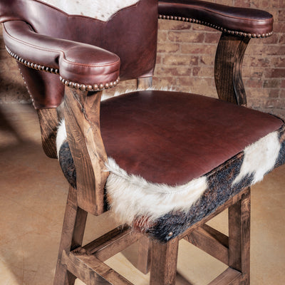 Seat detail of the High Plains Luxe Swivel Stool—brown leather seat with cowhide edge wrap, designed for comfortable everyday use at bar height seating.