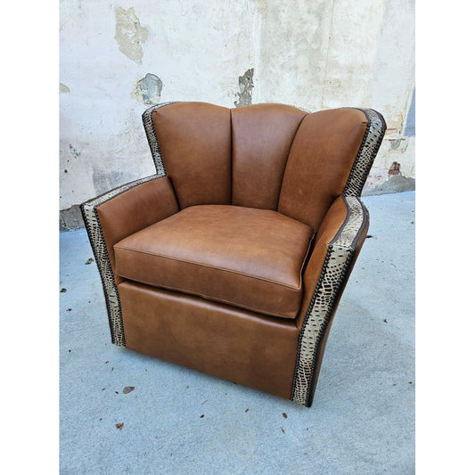 This Standard Cowboy Conch Chair is designed for maximum comfort and luxury. It features a large swiveling seat upholstered in top grain leather with a luxurious stamped crocodile leather trim and speckled cowhide. Exquisite craftsmanship and superior materials make this chair an ideal choice for any room.