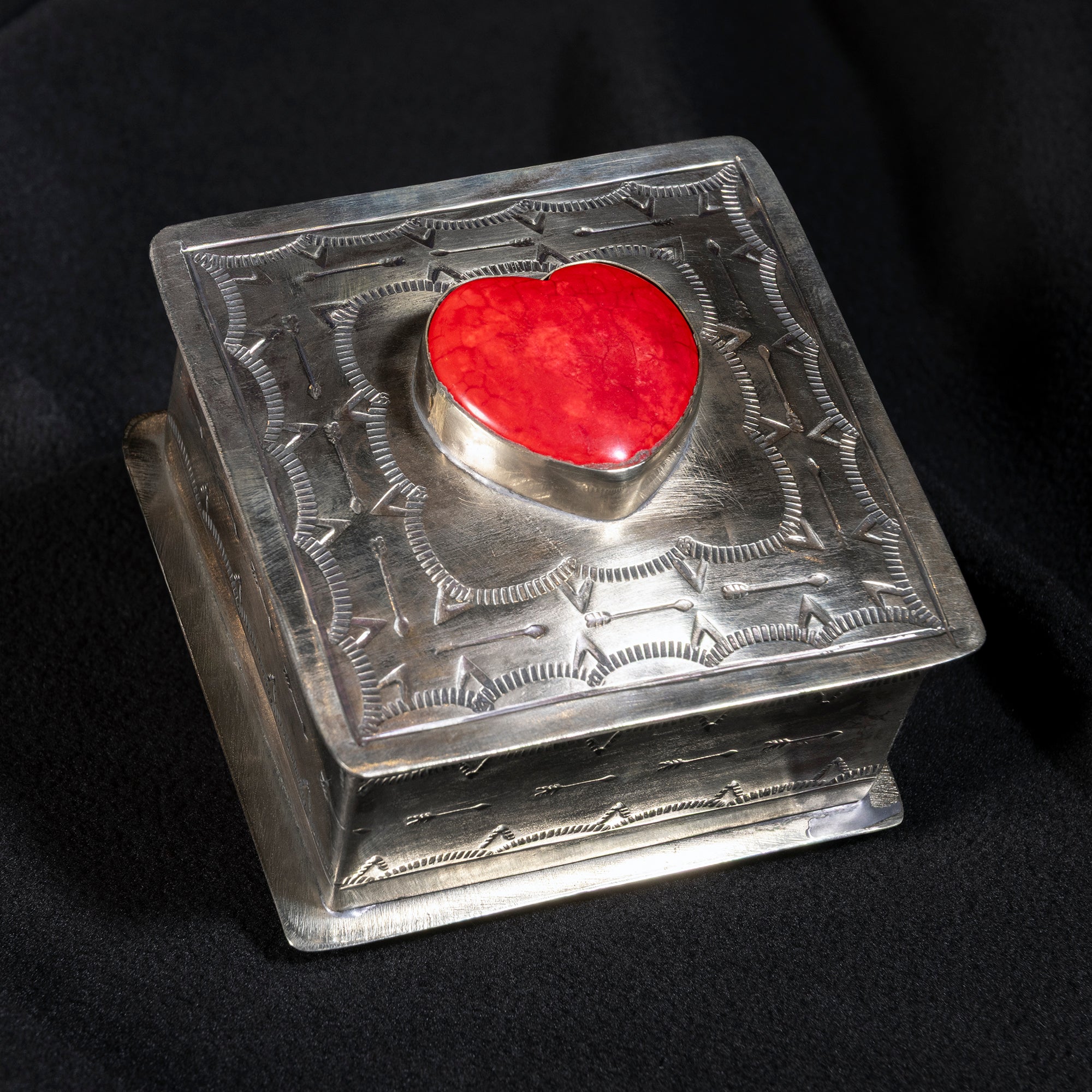 Side view of J. Alexander coral heart box showing Western arrow motifs and aged silver finish