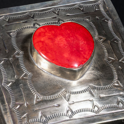 Close-up of heart-shaped coral stone set in hand-tooled German silver lid by J. Alexander