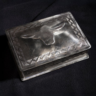 Side angle of handmade J. Alexander longhorn silver box showing Western stamped edges