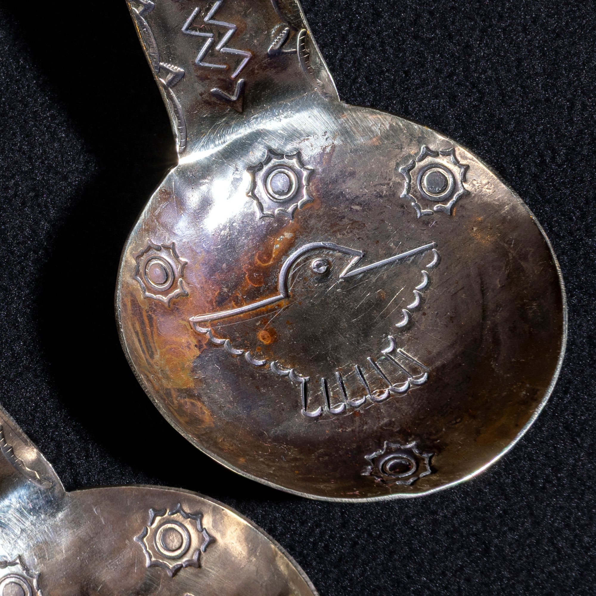 Close-up of Thunderbird engraving on hand-tooled German silver cigar holder by J. Alexander