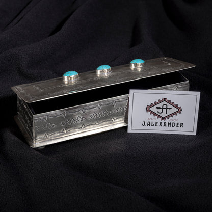 Open J. Alexander turquoise eyeglass box showing velvet-lined interior and hand-tooled silver craftsmanship