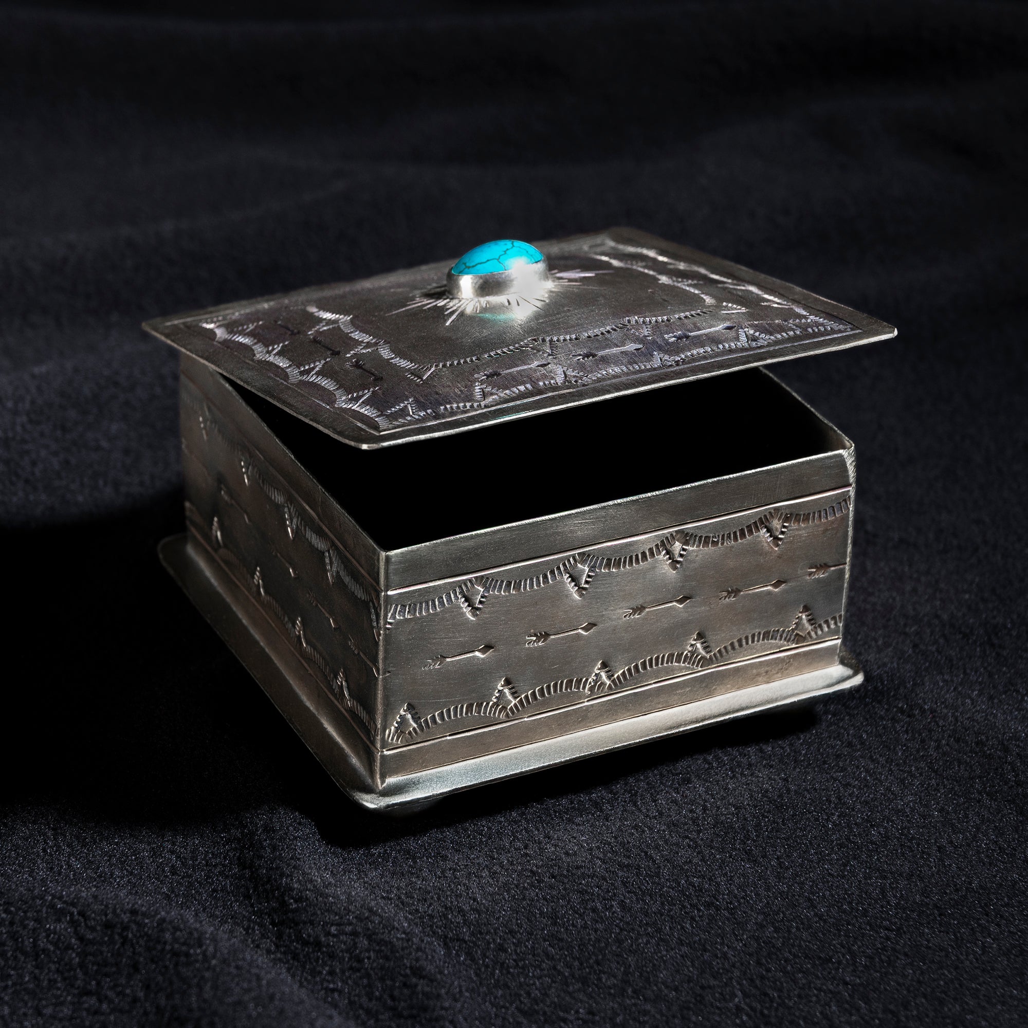 Open Santa Fe Turquoise Sunburst Box by J. Alexander showing velvet-lined interior and hand-tooled lid