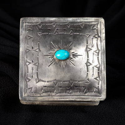 Top view of J. Alexander German silver sunburst box with center turquoise stone and hand-stamped Western pattern