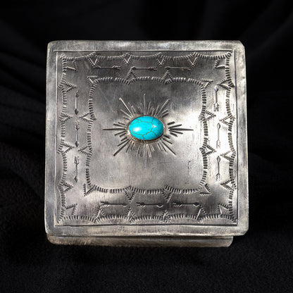Top view of J. Alexander German silver sunburst box with center turquoise stone and hand-stamped Western pattern