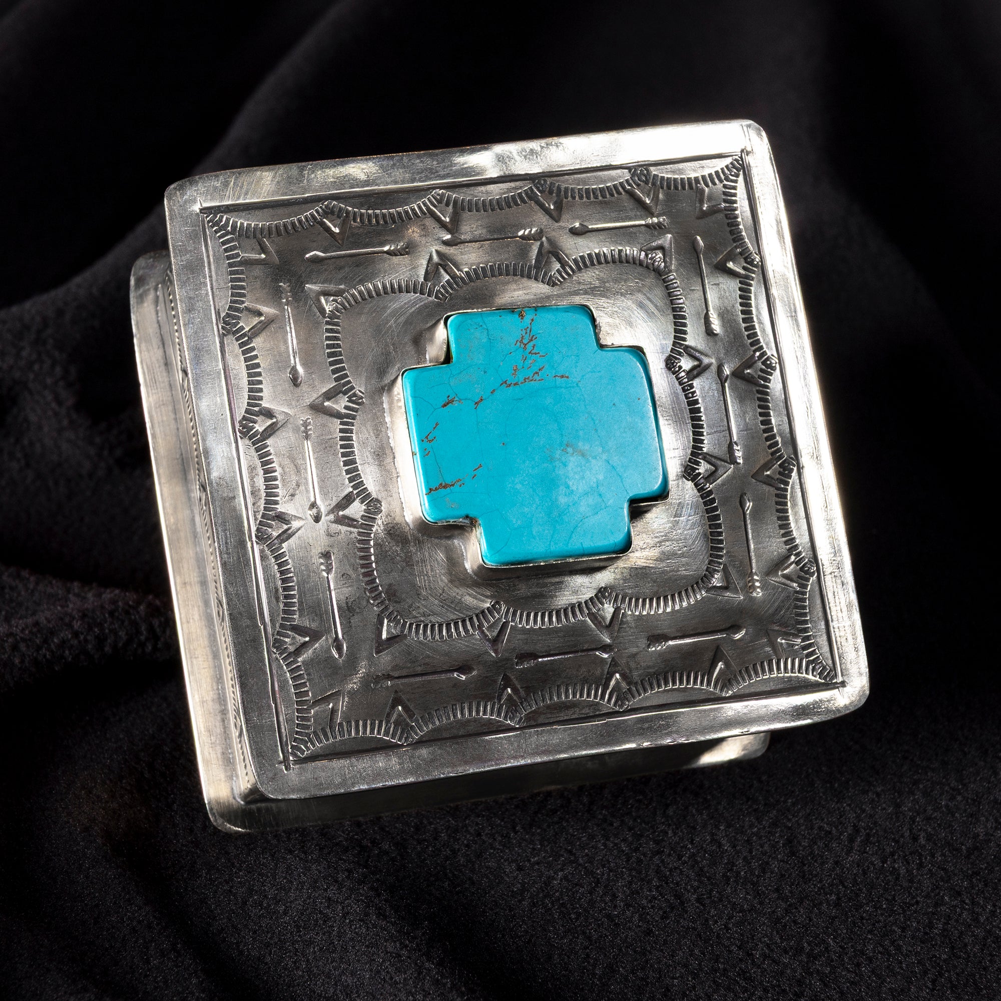 Top view of J. Alexander German silver box with raised turquoise cross and arrow motif pattern