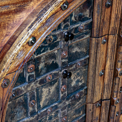 Close-up of riveted iron detailing on nightstand drawer front