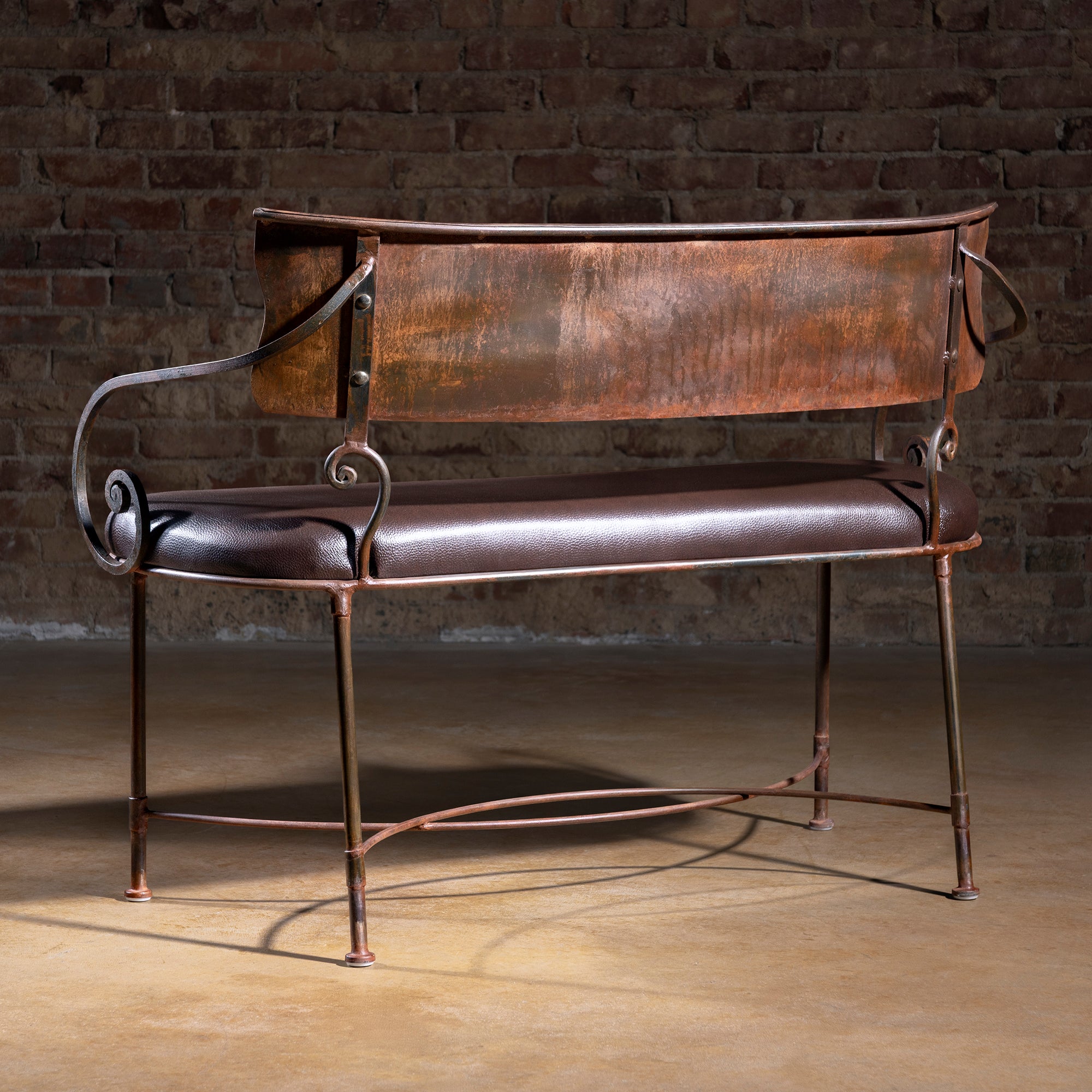 Back angle view of Ironwind Ranch Settee with weathered patina metal backrest