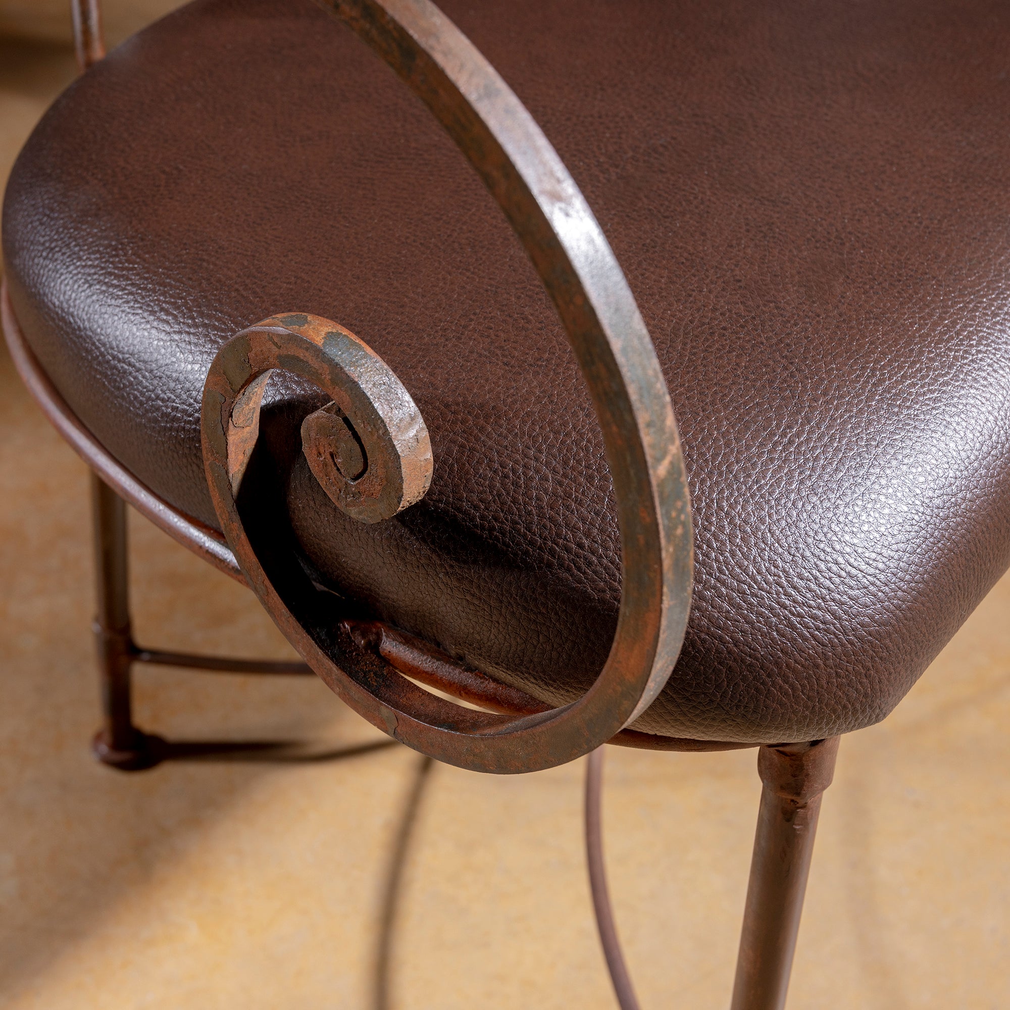 Close-up of scrollwork forged-iron arm on Ironwind Ranch Settee