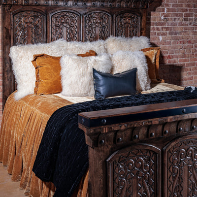 Close-up of hand-carved headboard with iron banding on Ironwood Carved Bed