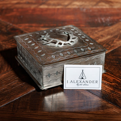 Hand-stamped silver trinket box by J. Alexander on wood table