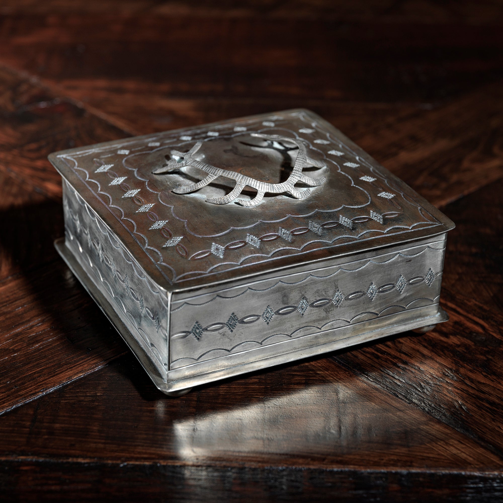Raised antler design on the lid of silver trinket box