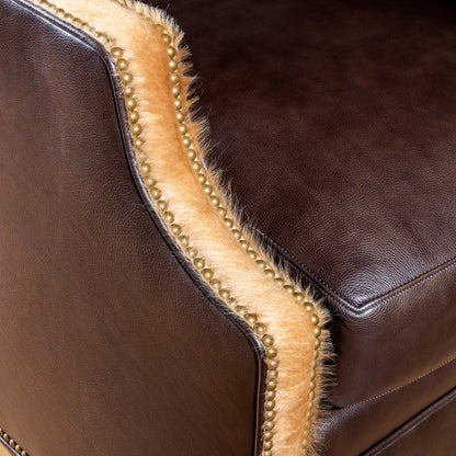 Nailhead trim and axis hide arm of Western chair