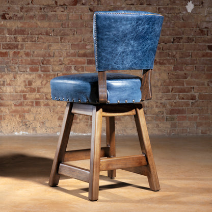 Back view of blue leather bar stool with rustic wood base