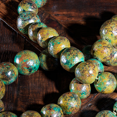 Close-up of verdigris ceramic beads with weathered patina finish