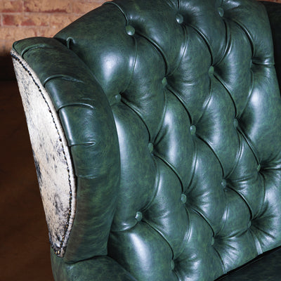 Detailed view of Brazilian cowhide and button tufting of custom Western accent chair