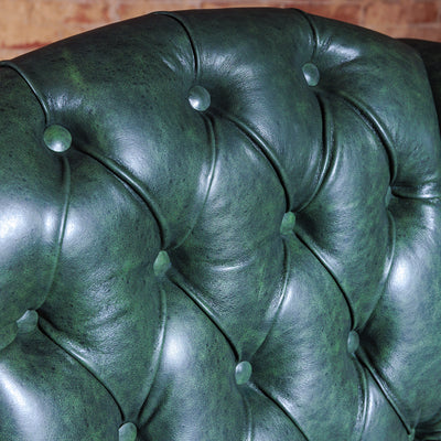 Button tufting detail of handcrafted Western leather and cowhide armchair with wood legs – Cattleman’s Retreat