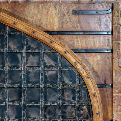 Detail of hand-forged iron and mango wood headboard