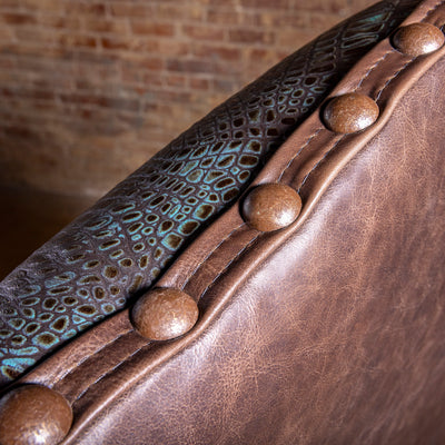 Nailhead and concho-style accent detail on Western leather executive desk chair with croc-embossed trim
