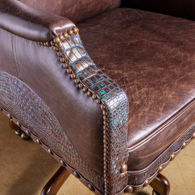 Western leather desk chair arm detail with turquoise copper croc-embossed leather wrap and nailhead trim