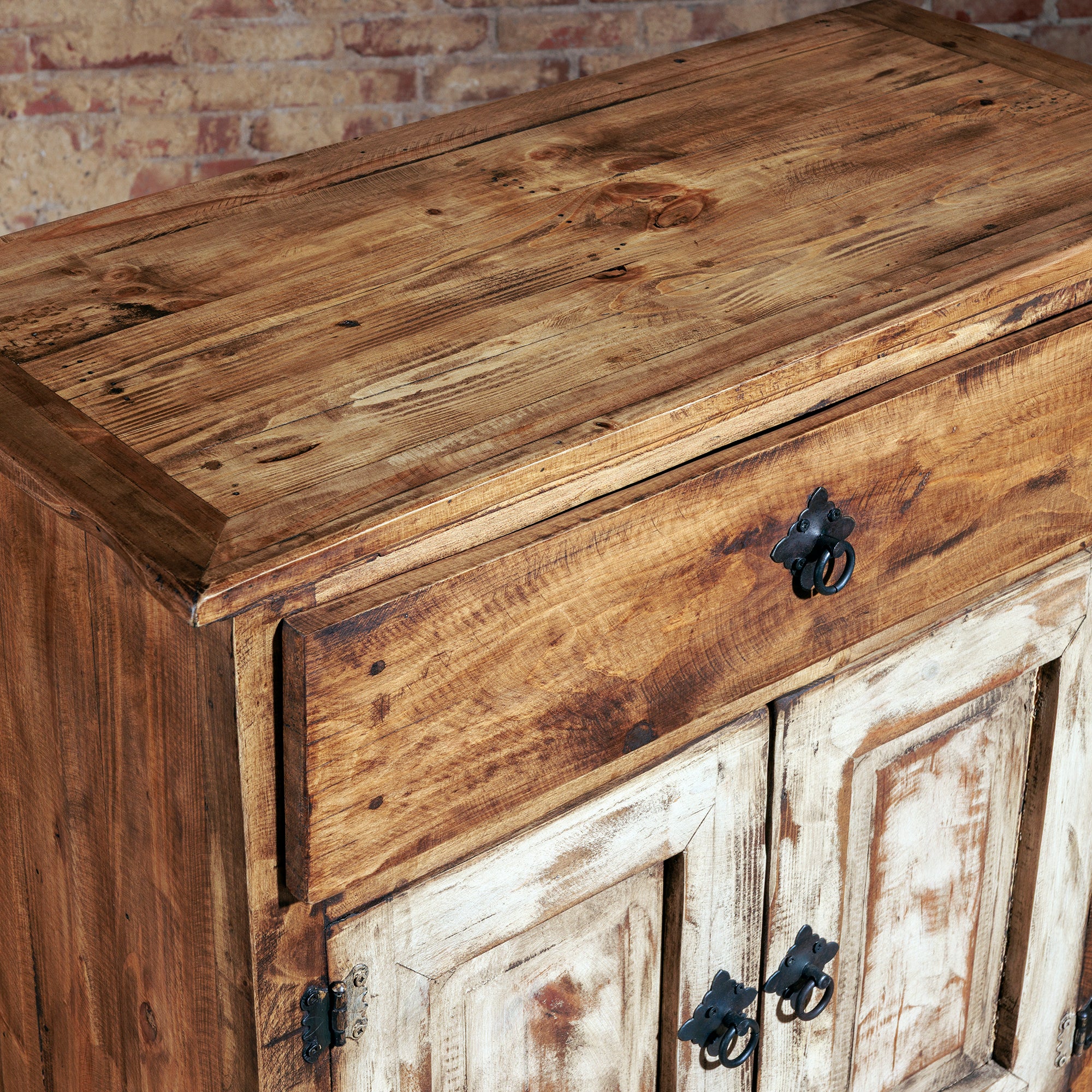 High angle view of rustic wood console with whitewashed door panels