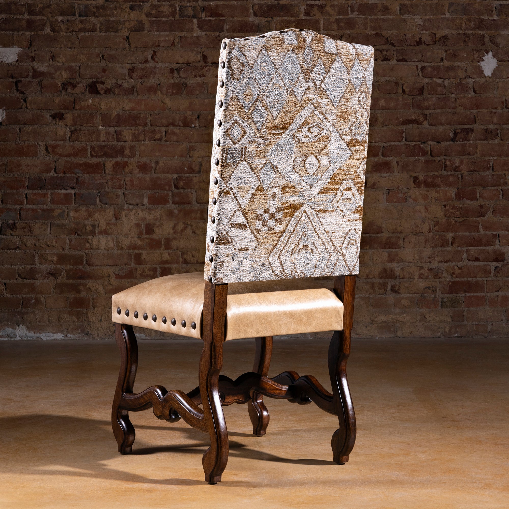 Back view of the Mariposa Crest Dining Chair with patterned fabric and nailhead trim