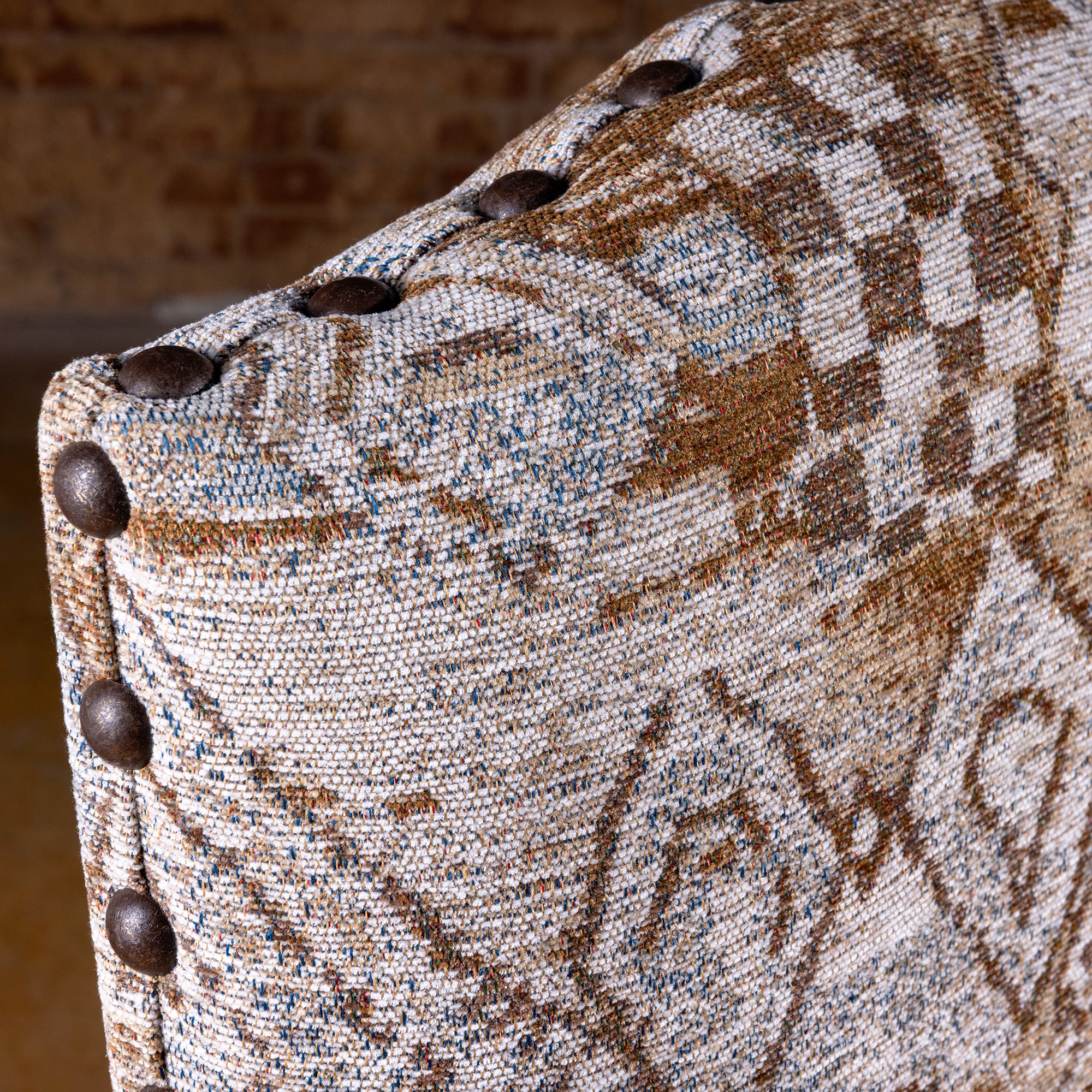 Fabric and nailhead trim detail of the Mariposa Crest Dining Chair