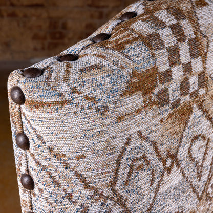 Fabric and nailhead trim detail of the Mariposa Crest Dining Chair