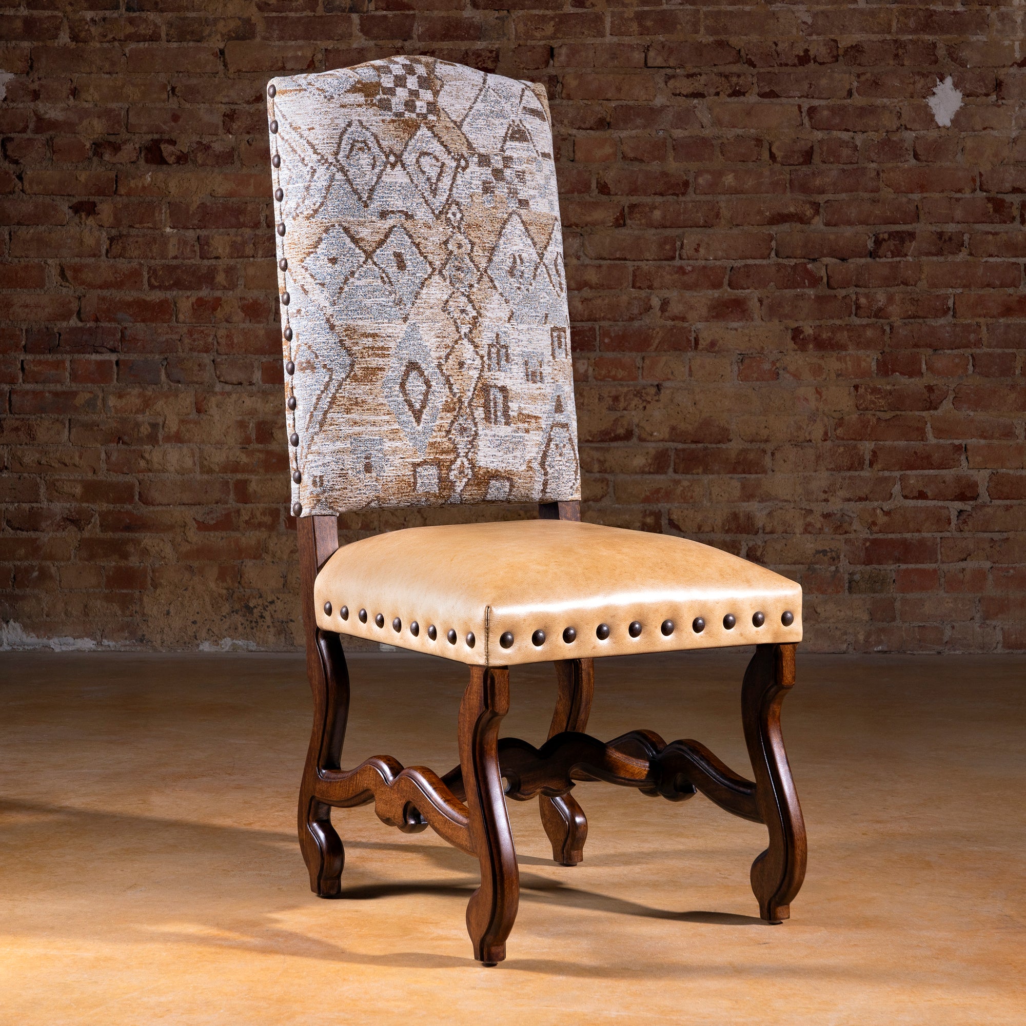 Full view of the Mariposa Crest Dining Chair showing alder wood frame, fabric back, and leather seat