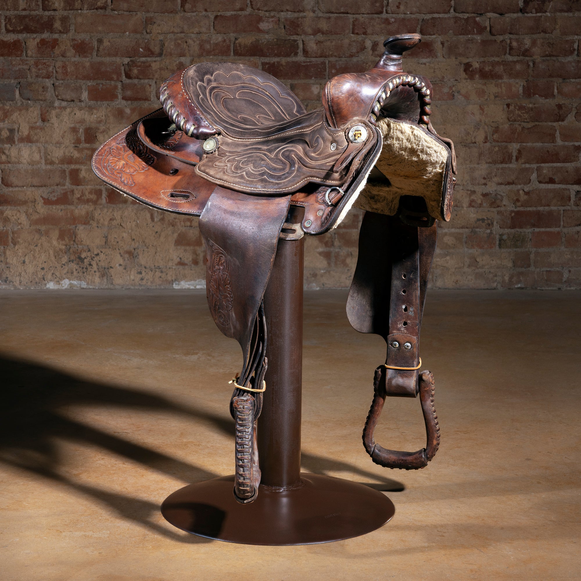 Mesa Canyon Western saddle bar stool with tooled leather saddle on iron pedestal base