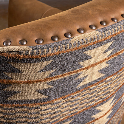 Nailhead trim detail on Pendleton fabric and leather swivel chair