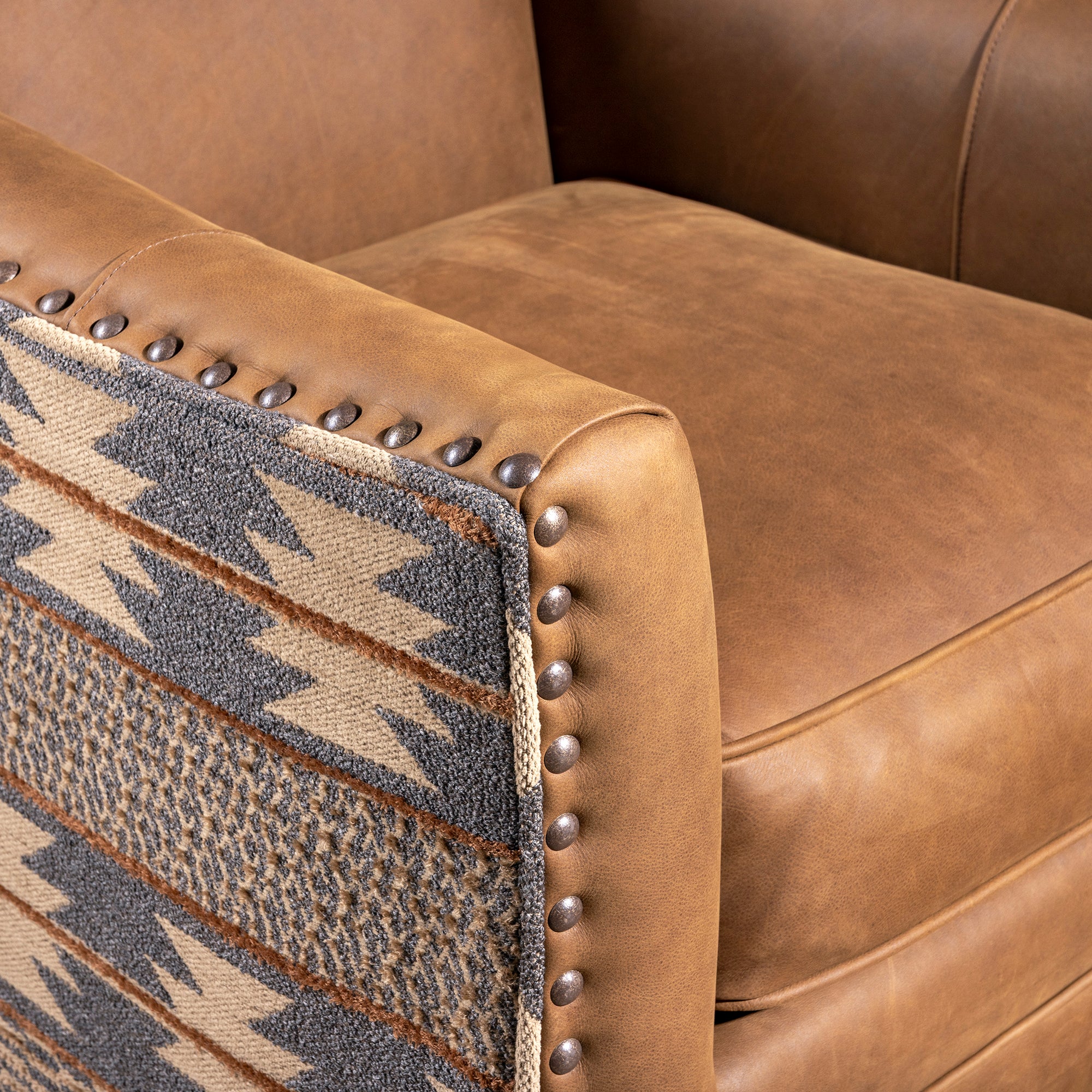 Top-grain leather seat and arm detail on Western swivel chair