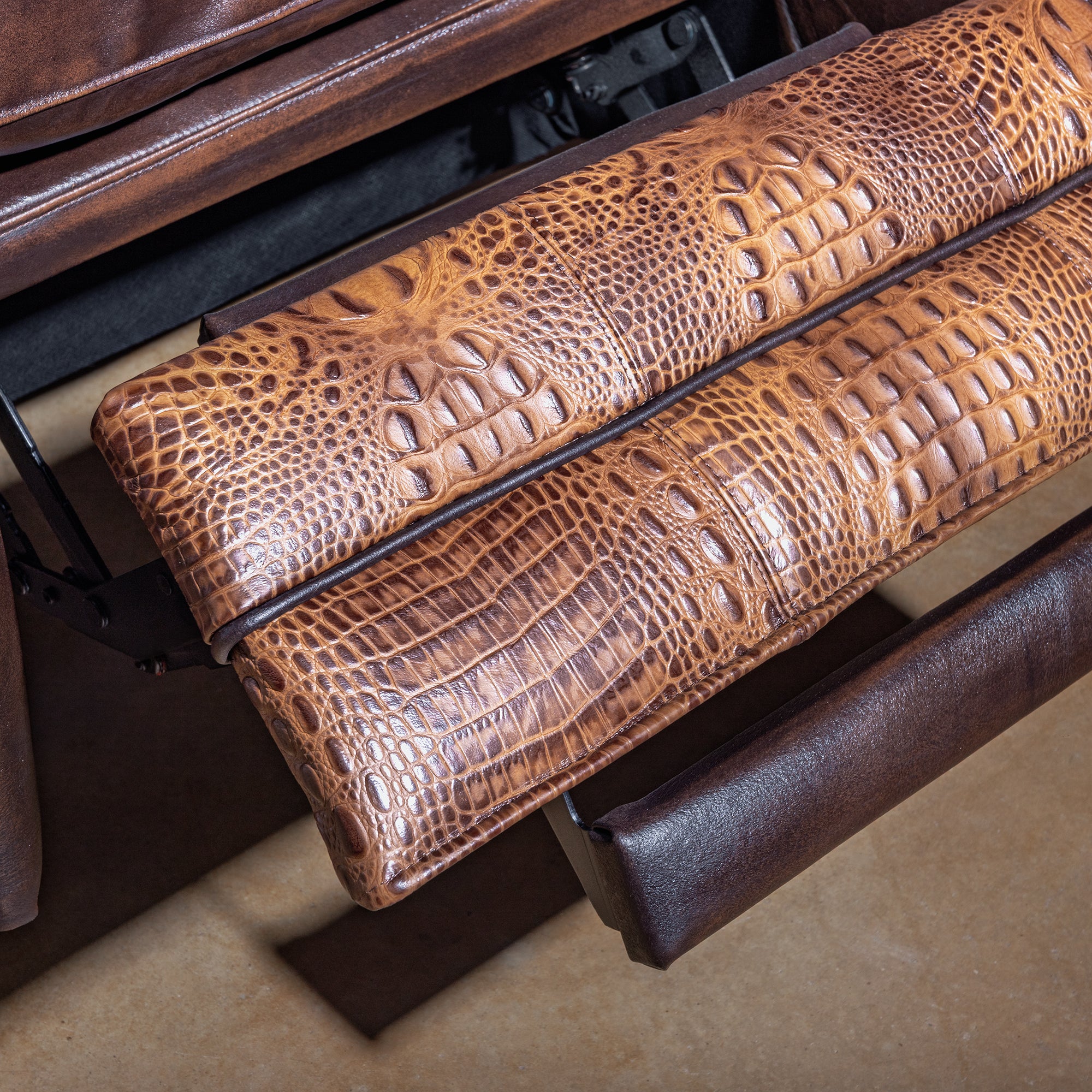 Mojave Gatorline Recliner western bustleback leather recliner footrest detail with croc-embossed leather and rich brown finish.