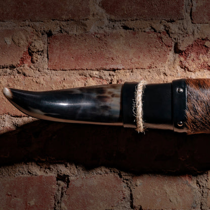 Close-up of horn tip and stitched leather with cowhide wrap on mounted longhorn wall art