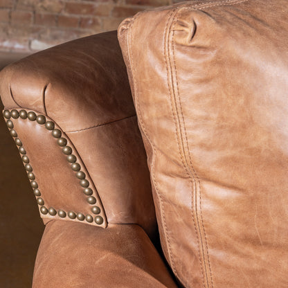 Back cushion and arm detail on Oakley Frontier Western leather couch in saddle tan leather