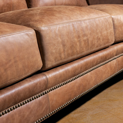 Front rail and nailhead trim closeup on Oakley Frontier top grain leather Western sofa