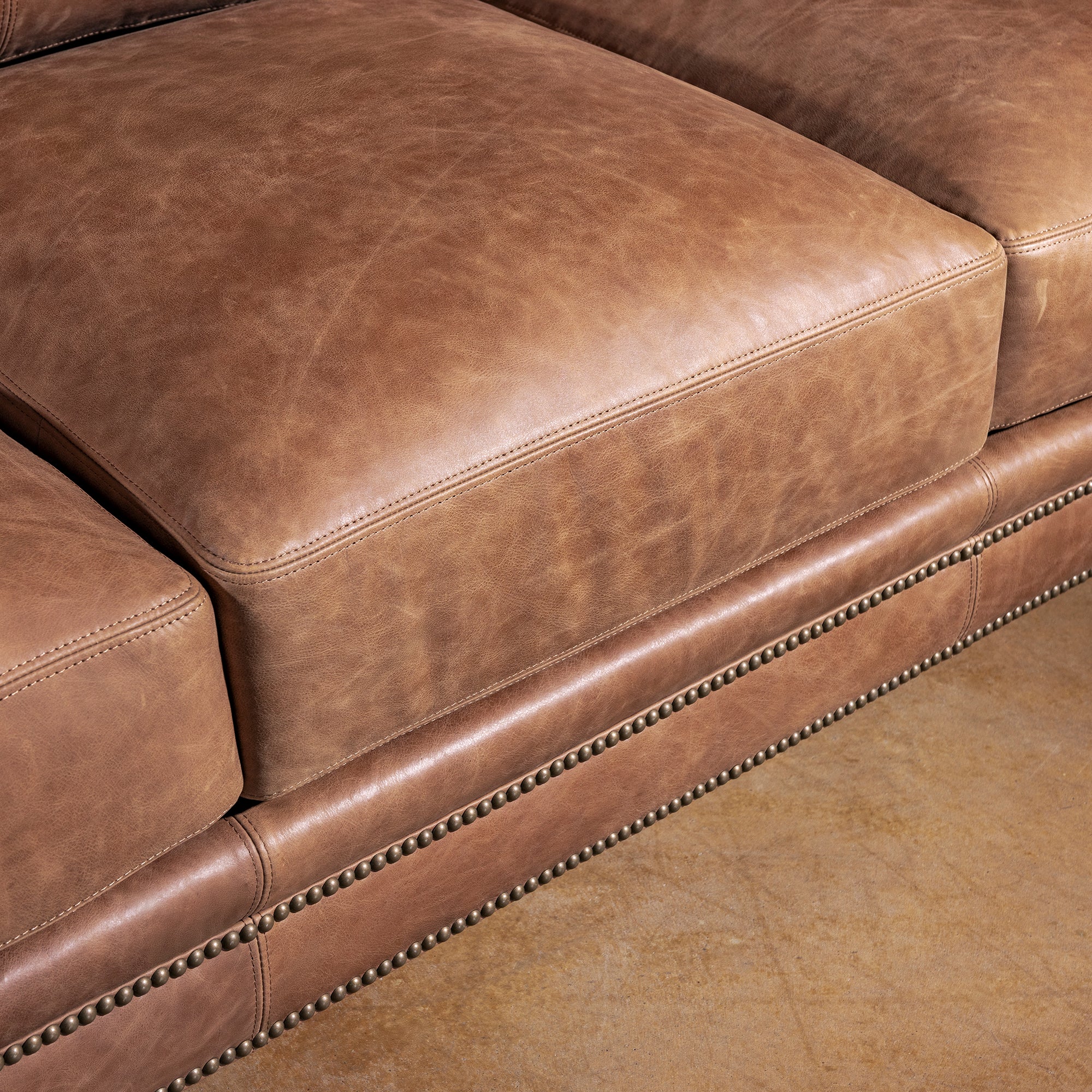 Seat cushion closeup of Oakley Frontier tan top grain leather sofa for ranch living room