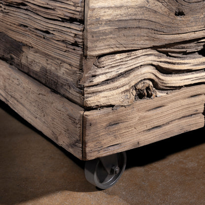 Bottom corner detail of Outlaw Freight Trunk Coffee Table with weathered wood and caster wheels