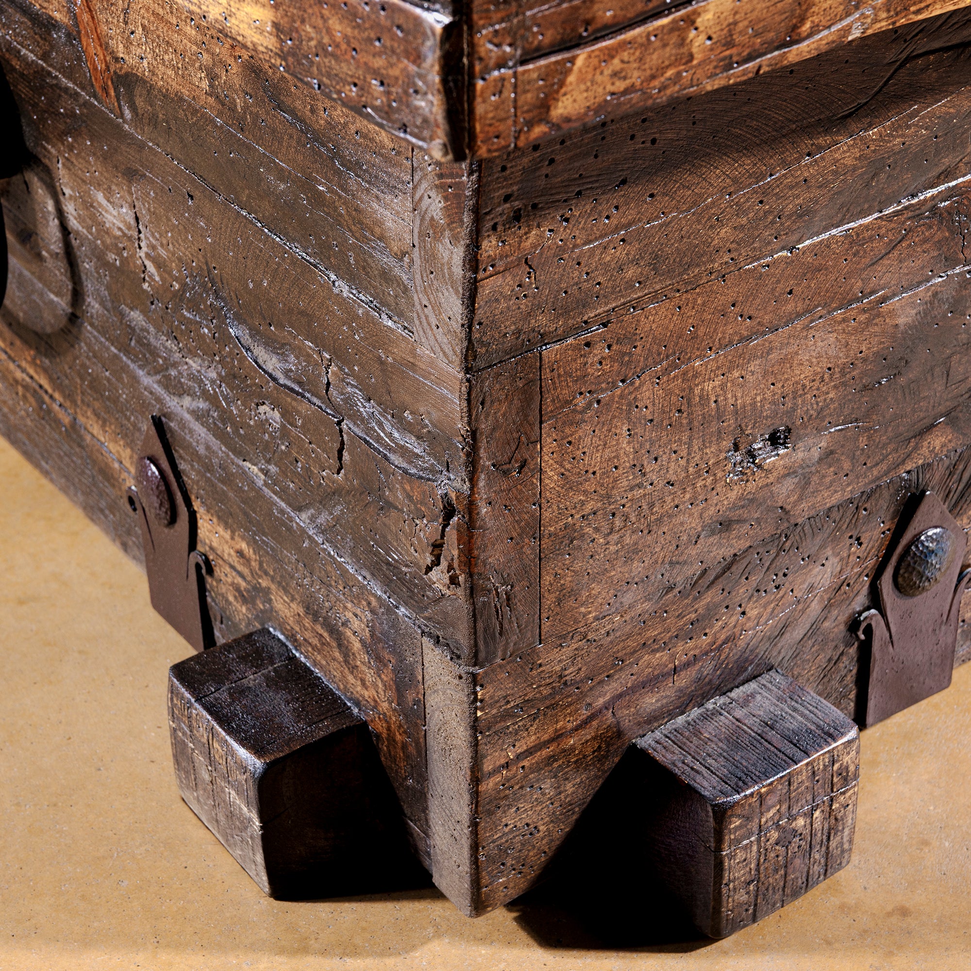 Close-up corner detail of reclaimed wood texture on Outpost Timberlock Trunk Table