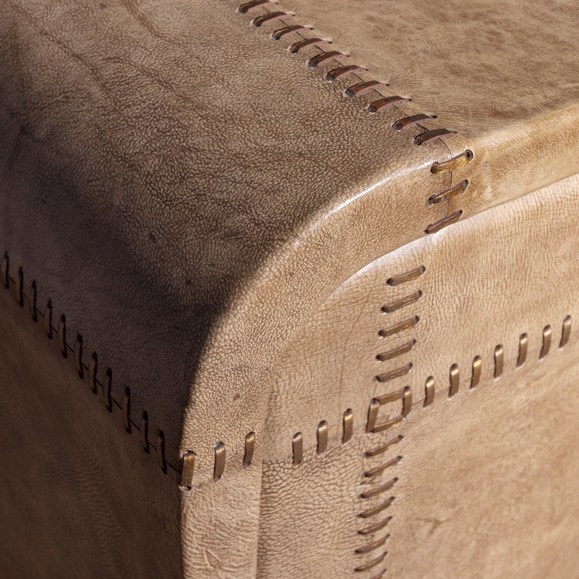 Palisade Bone Buffet western buffet corner detail showing bone leather upholstery, rounded edge, and hand-finished stitched seams.