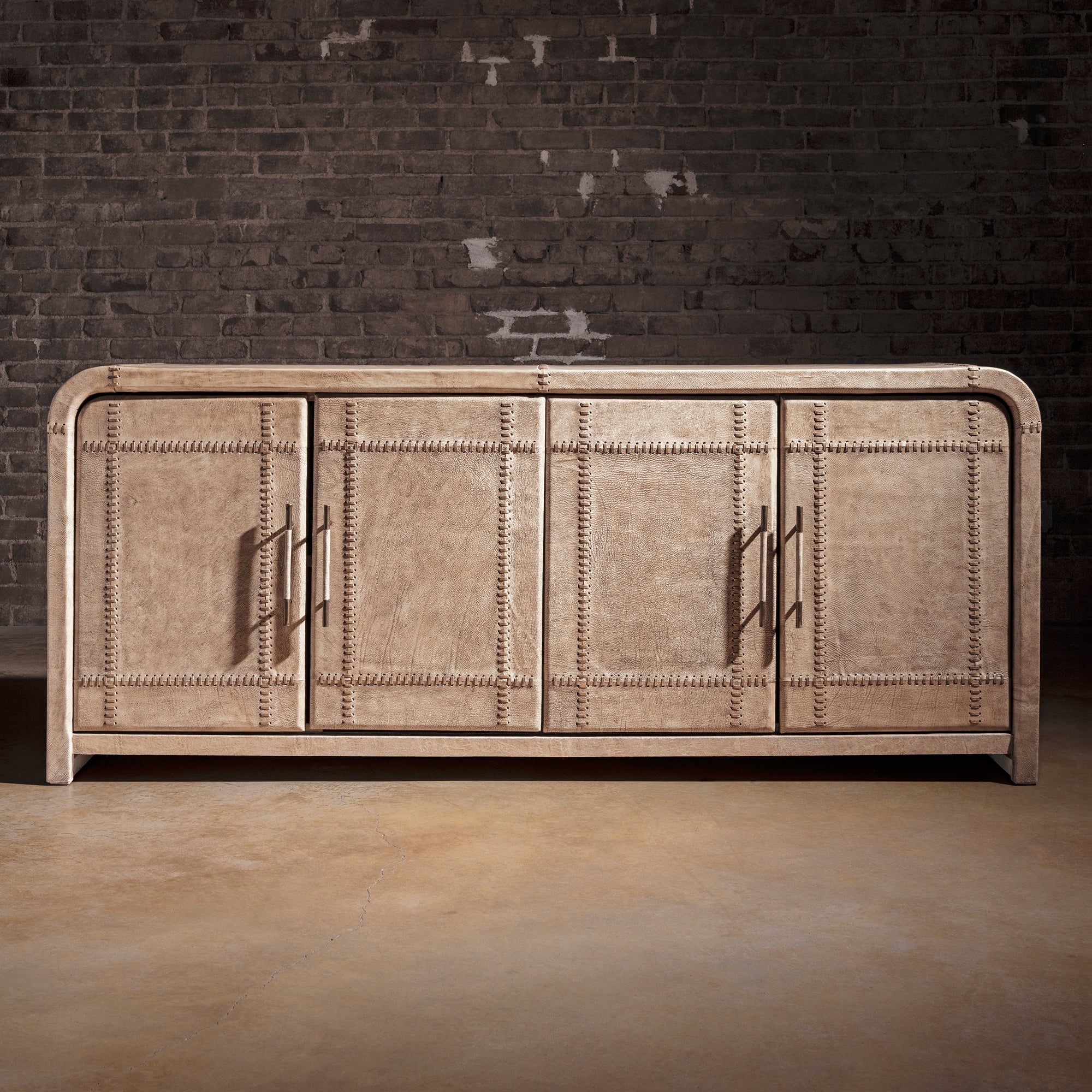 Palisade Bone Buffet western buffet front view with four leather-paneled doors, rounded corners, and modern ranch silhouette.