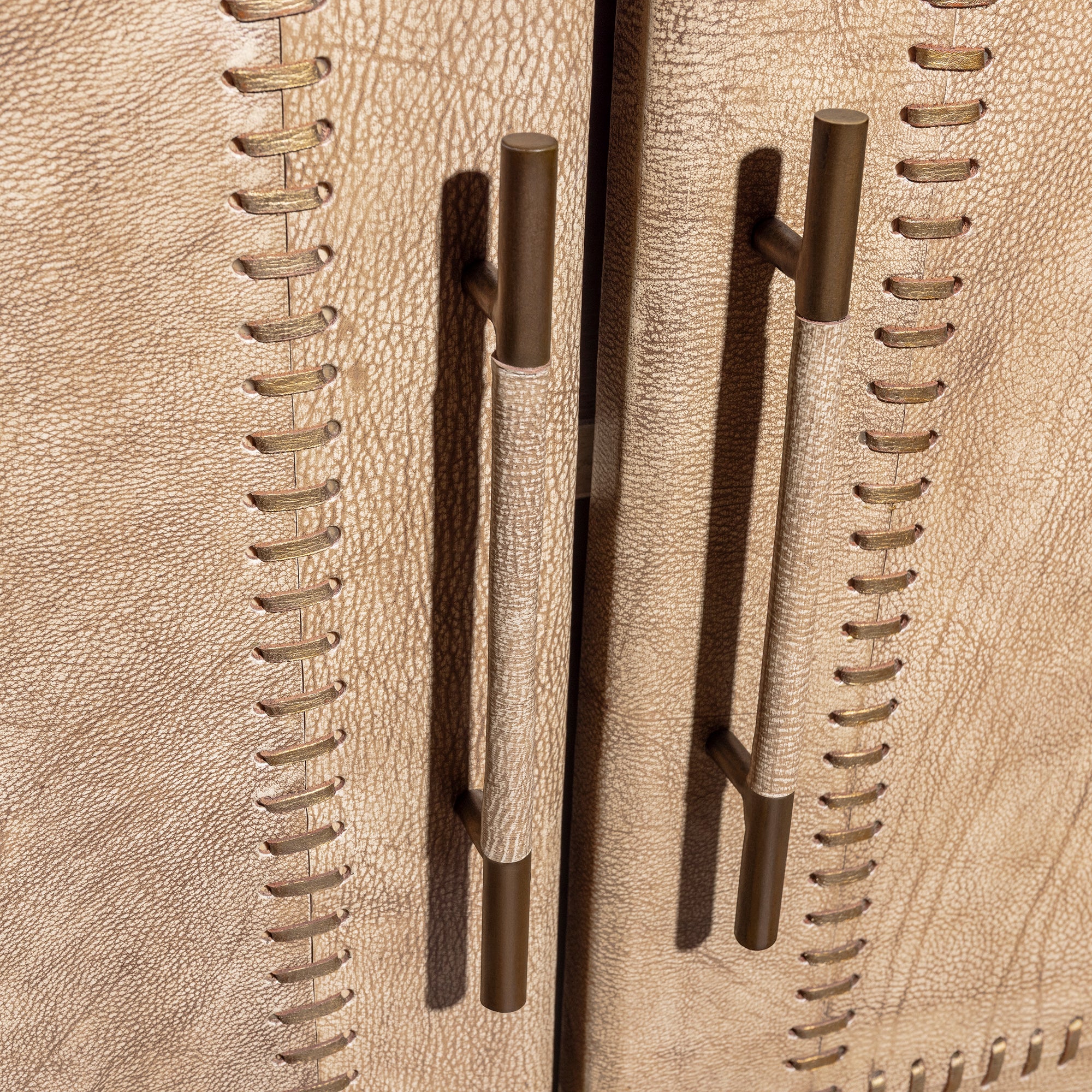 Palisade Bone Buffet western buffet handle detail with bronze-toned pulls and bone leather paneled cabinet doors.