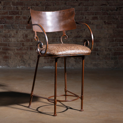 Western iron bar stool with copper-toned backrest, scroll arms, and tooled leather seat cushion