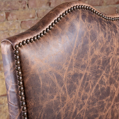 Nailhead trim along arched backrest of Pecos Canyon Western leather dining chair