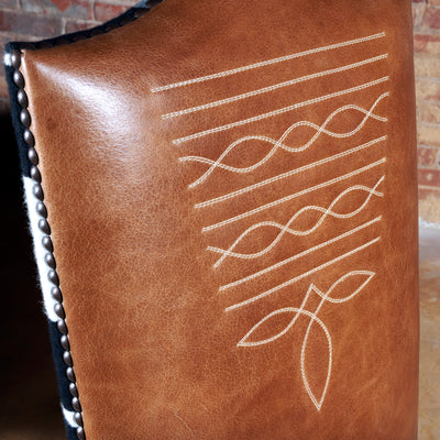 Detailed view of cowboy boot stitch embroidery on leather back
